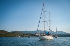 Photo by mali maeder White and Black Boat Surrounded by Body of Water Under Blue Sky